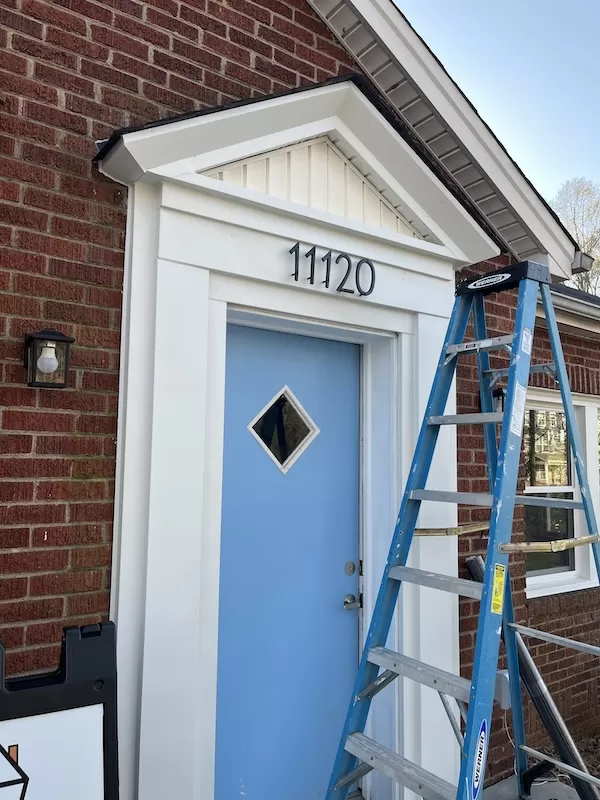 Blue front doorway with address numbers